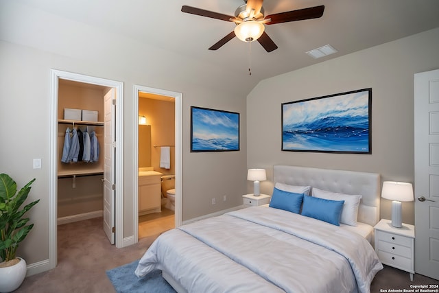 bedroom featuring ensuite bath, a spacious closet, ceiling fan, carpet floors, and a closet