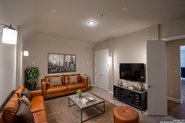 living room featuring vaulted ceiling