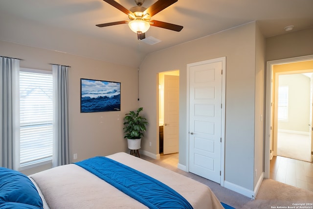 carpeted bedroom featuring ceiling fan and lofted ceiling