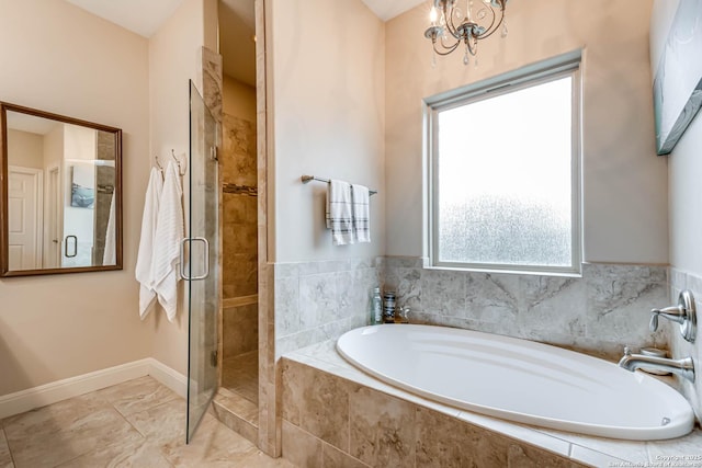 bathroom featuring shower with separate bathtub and a notable chandelier