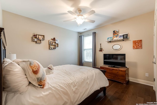 bedroom with dark hardwood / wood-style floors and ceiling fan