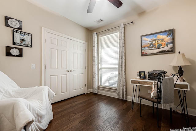 living area with ceiling fan and dark hardwood / wood-style flooring