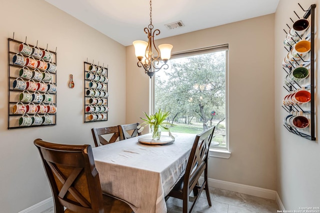 dining room featuring light tile patterned flooring and a chandelier