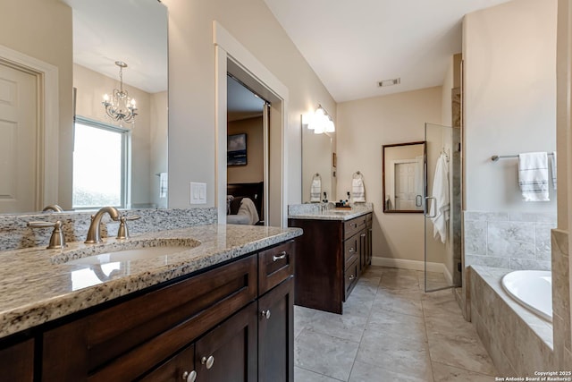 bathroom featuring vanity, tile patterned floors, a chandelier, and separate shower and tub