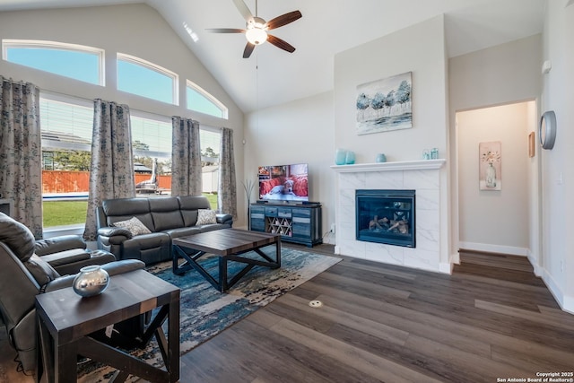 living room with a fireplace, dark hardwood / wood-style flooring, high vaulted ceiling, and ceiling fan