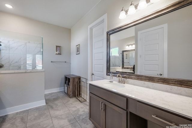 bathroom with tile patterned floors, vanity, and walk in shower