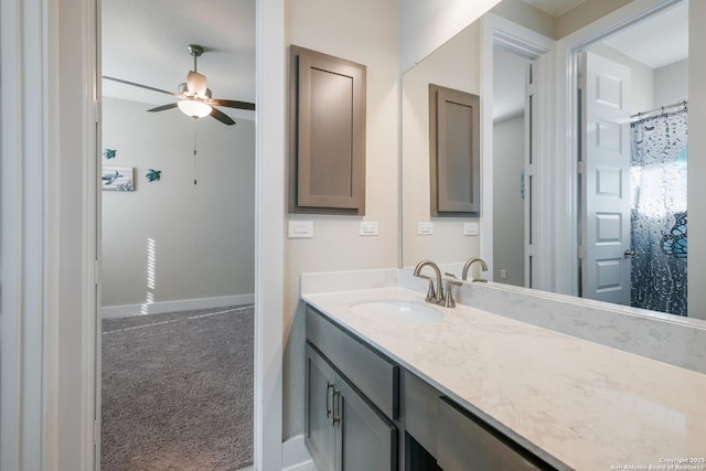 bathroom with vanity, ceiling fan, and curtained shower