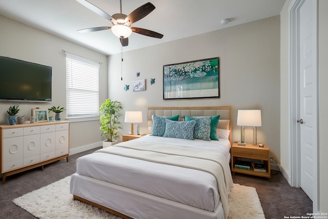 bedroom featuring ceiling fan and dark carpet