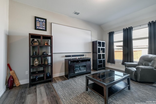 living room featuring lofted ceiling and dark wood-type flooring