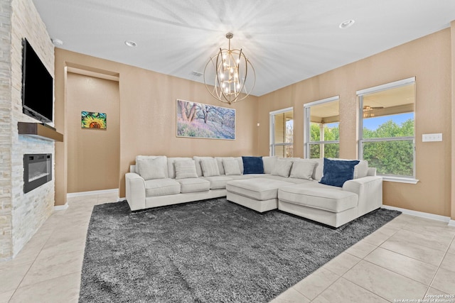 tiled living room with a fireplace and a chandelier