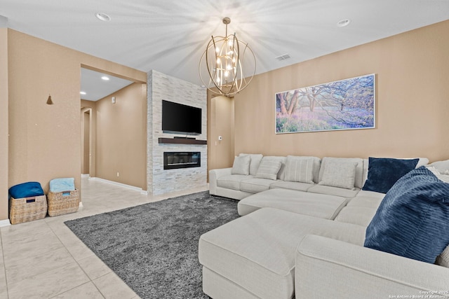 living room featuring a notable chandelier, light tile patterned floors, and a fireplace