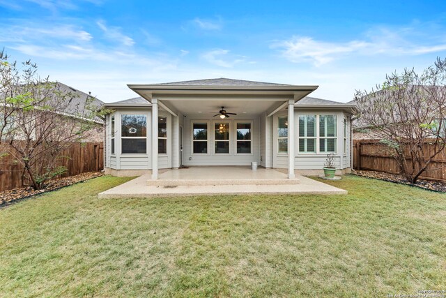 rear view of house featuring a patio, ceiling fan, and a lawn