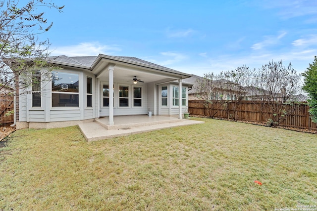 back of house featuring a lawn, ceiling fan, and a patio