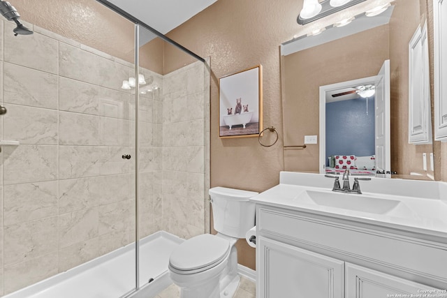 bathroom featuring vanity, ceiling fan, toilet, and walk in shower