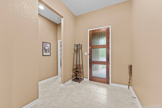 foyer entrance with light tile patterned flooring