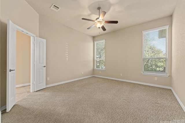 carpeted empty room with ceiling fan