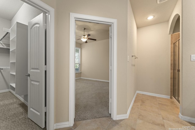 hall with light colored carpet