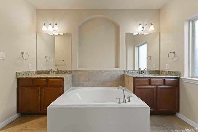 bathroom featuring tile patterned flooring, vanity, and a bathtub