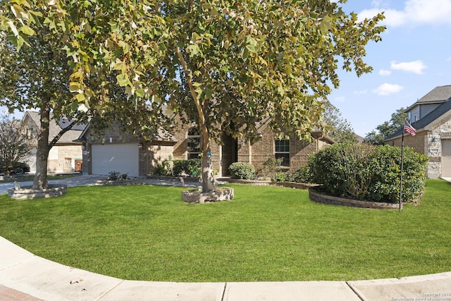 view of property hidden behind natural elements featuring a garage and a front yard