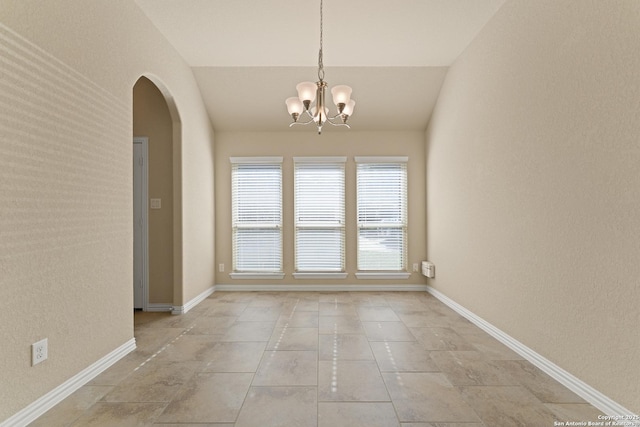 unfurnished room featuring a notable chandelier