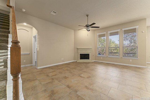 unfurnished living room with ceiling fan