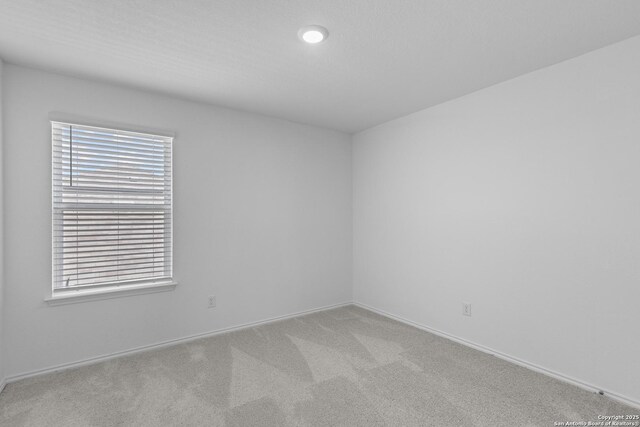 unfurnished room with light colored carpet