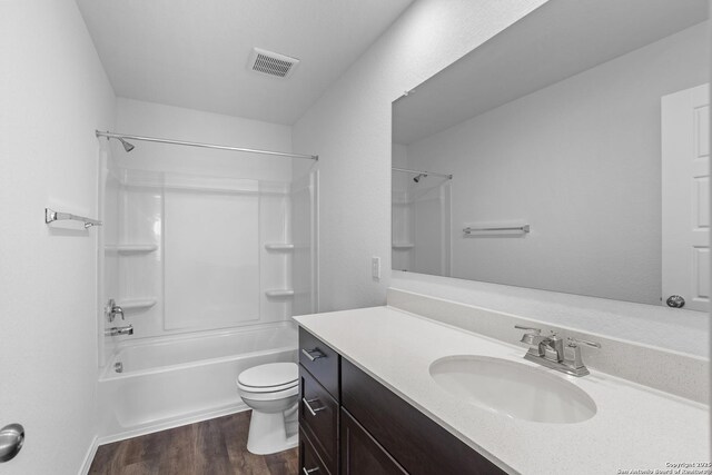 full bathroom with vanity, toilet, shower / bathing tub combination, and hardwood / wood-style flooring