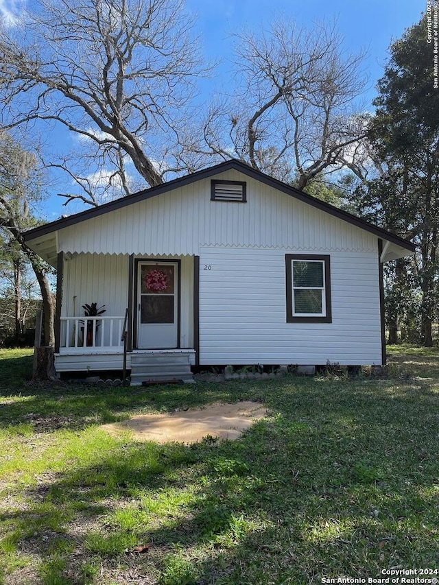 view of front of house featuring a front yard and a porch