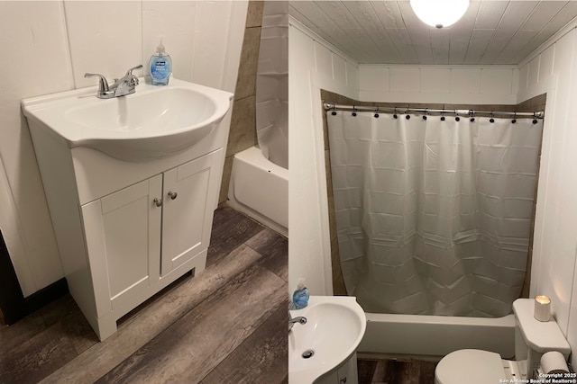 full bathroom featuring vanity, toilet, hardwood / wood-style floors, and shower / tub combo