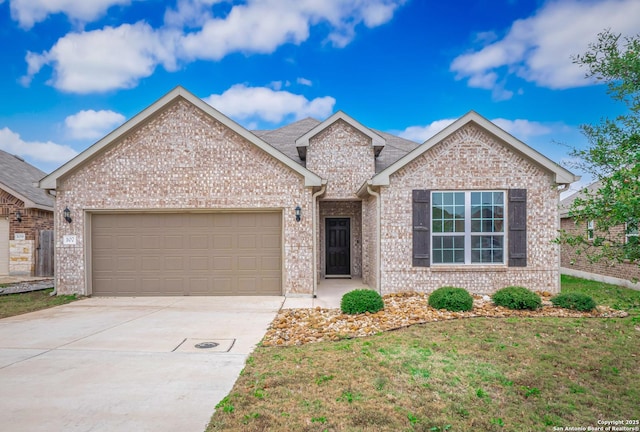 view of front of property featuring a front yard and a garage