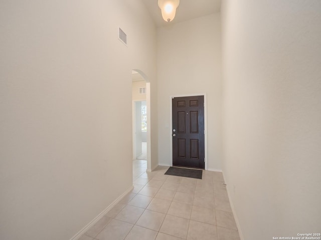 tiled entrance foyer with a high ceiling