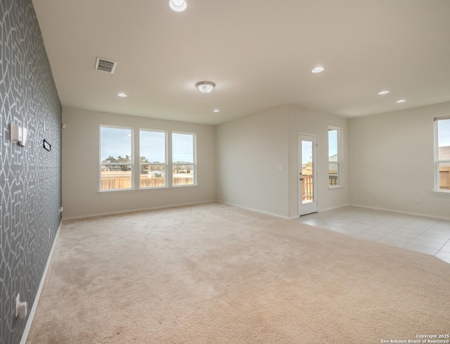 unfurnished room with light colored carpet