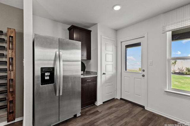 kitchen featuring dark brown cabinetry, stainless steel fridge with ice dispenser, and dark hardwood / wood-style flooring