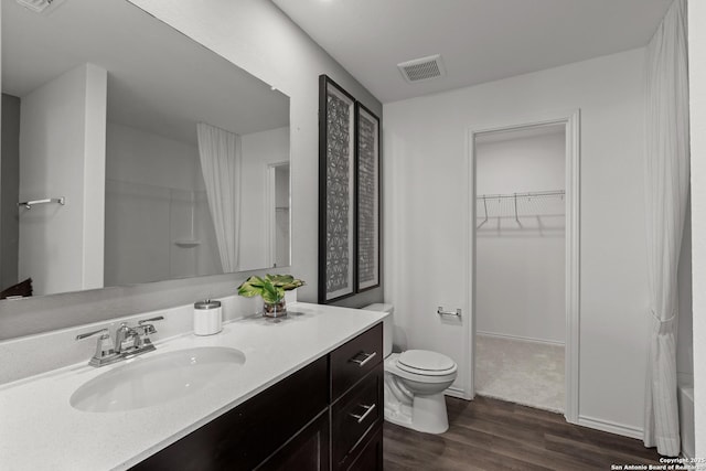 bathroom featuring hardwood / wood-style floors, vanity, and toilet