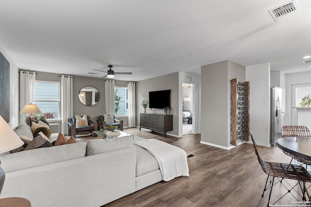 living room featuring dark hardwood / wood-style floors and ceiling fan