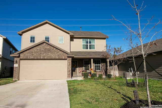 view of front facade featuring covered porch, a garage, and a front lawn