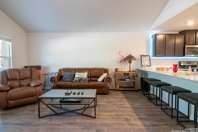 living room with dark hardwood / wood-style floors and lofted ceiling