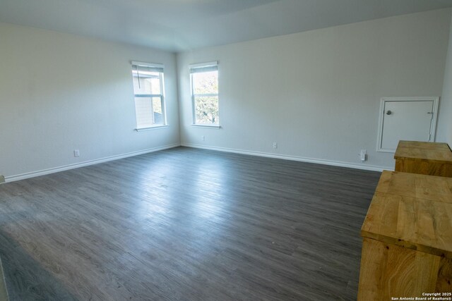 spare room with dark wood-type flooring