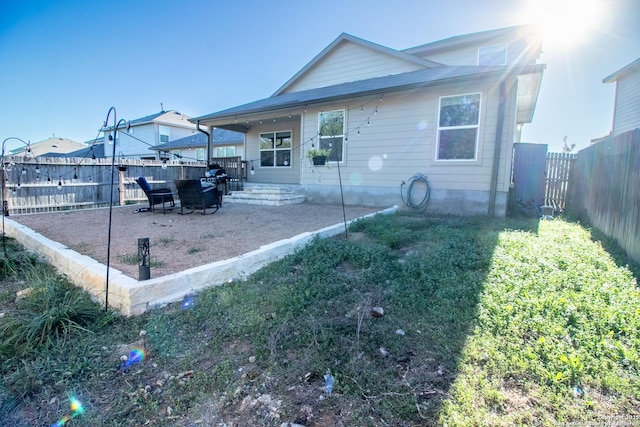 rear view of house featuring a yard