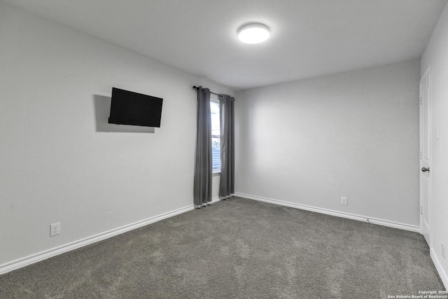 empty room featuring dark colored carpet