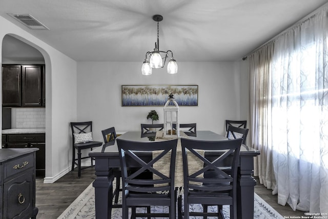 dining space with dark wood-type flooring