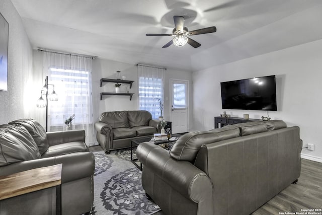 living room featuring dark hardwood / wood-style floors, ceiling fan, and a healthy amount of sunlight