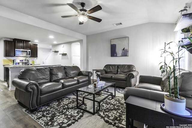 living room featuring hardwood / wood-style floors, ceiling fan, and lofted ceiling