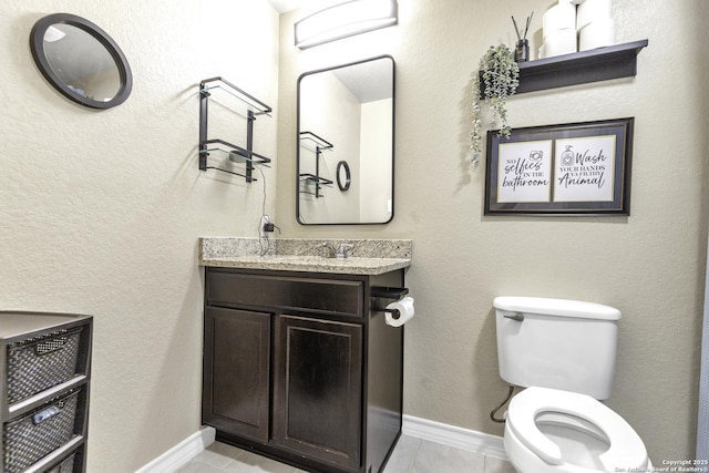 bathroom featuring toilet, vanity, and tile patterned floors