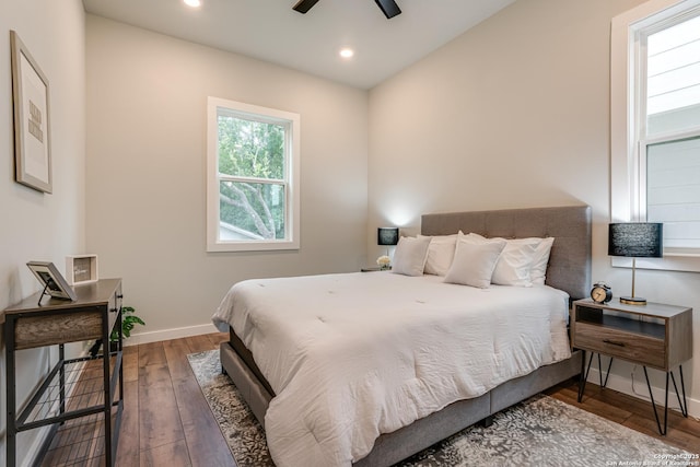 bedroom with ceiling fan and dark hardwood / wood-style flooring