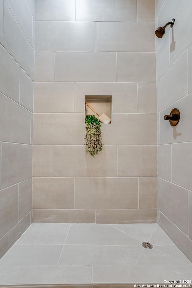 bathroom with tiled shower