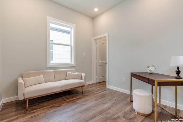 living area with hardwood / wood-style flooring