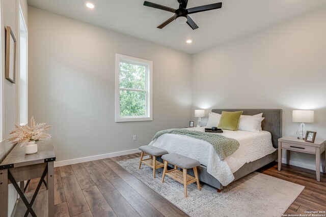 bedroom with dark hardwood / wood-style flooring and ceiling fan