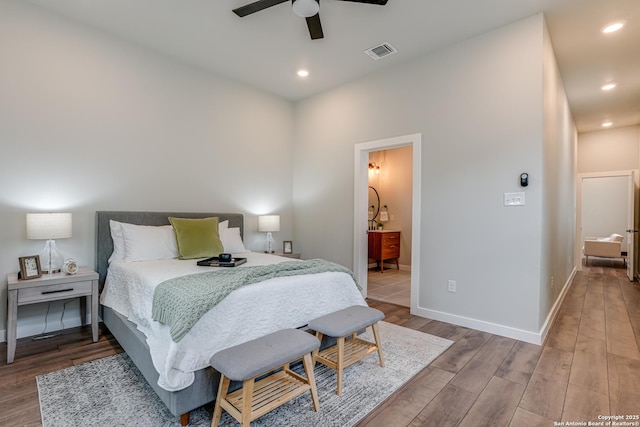 bedroom featuring hardwood / wood-style floors, connected bathroom, and ceiling fan