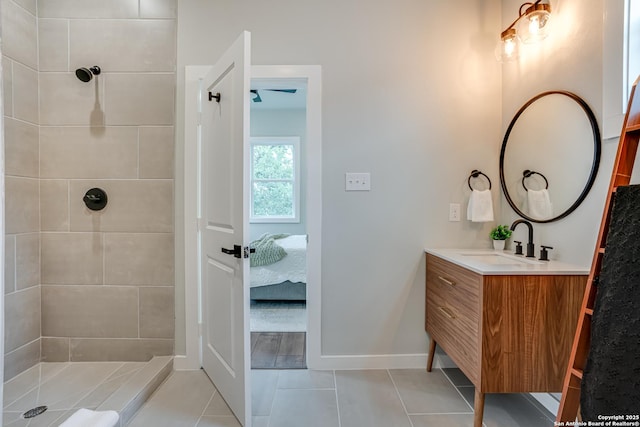 bathroom with tile patterned flooring, vanity, and tiled shower